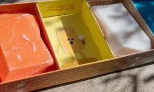 Erste Eindrücke von Duschbrocken: Ein orangefarbener, ein gelber mit Comic und ein weißer festes Shampoo. Umweltfreundlich & pflegend.