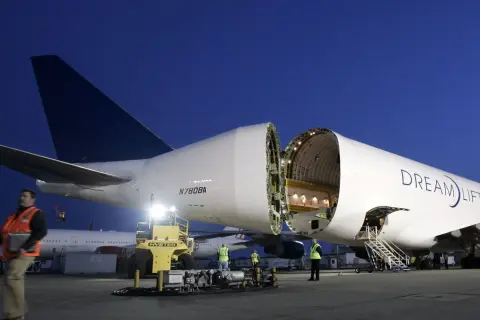 Ein Frachtflugzeug mit geöffneter Nase, bereit, Träume zu transportieren. Der Schriftzug "Dream Lifter" prangt auf dem Rumpf.