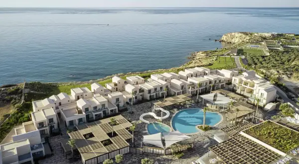 Robinson Ierapetra: moderne Anlage mit weißen Häusern, Pools und Blick aufs Meer.