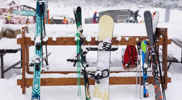 Skier und Snowboarder warten auf die Piste. Die Ausrüstung ist bereit, eine perfekte Checkliste Skifahren.