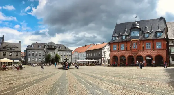 Ein belebter Marktplatz mit historischen Fachwerkhäusern und einem Brunnen. Perfekt für Ausflugsziele Niedersachsen.