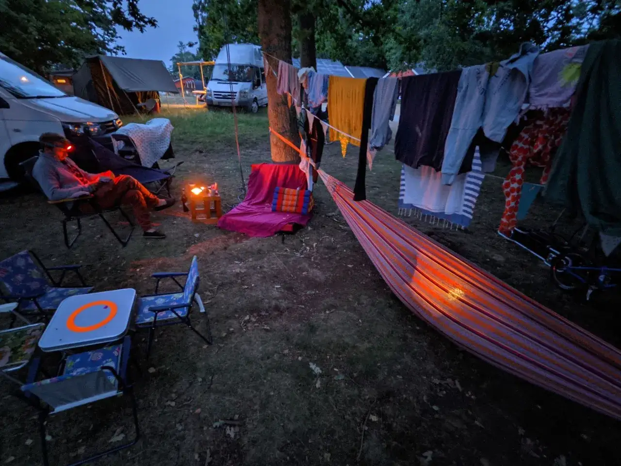 Gemütlicher Abend auf dem Campingplatz: Wäsche trocknet, Hängematte lädt ein. Perfekt für die packliste camping mit kindern.