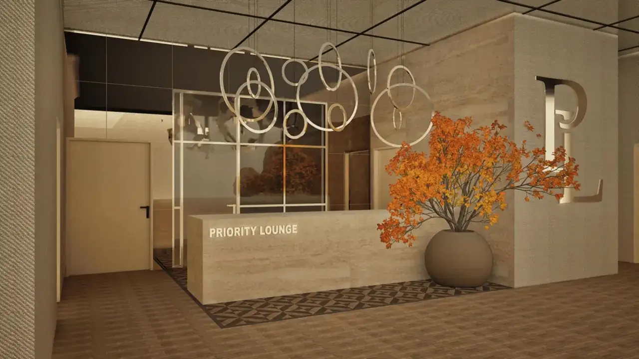 Eingang zur Priority Lounge am Flughafen. Ein eleganter Empfangsbereich mit einem großen Blumenarrangement und einem stilvollen Logo.