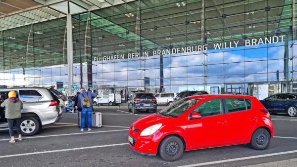 Am Flughafen Berlin Brandenburg Willy Brandt parken Autos. Die Kosten für das Parken sind hier nicht ersichtlich, aber die An- und Abfahrt ist gut organisiert.